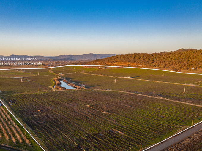Rogue Valley Irrigated Farm with 302.22 Acres of Water Rights seen from the air, with low mountains in the background